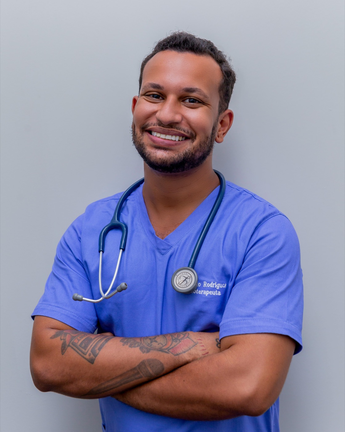 A smiling healthcare worker in scrubs