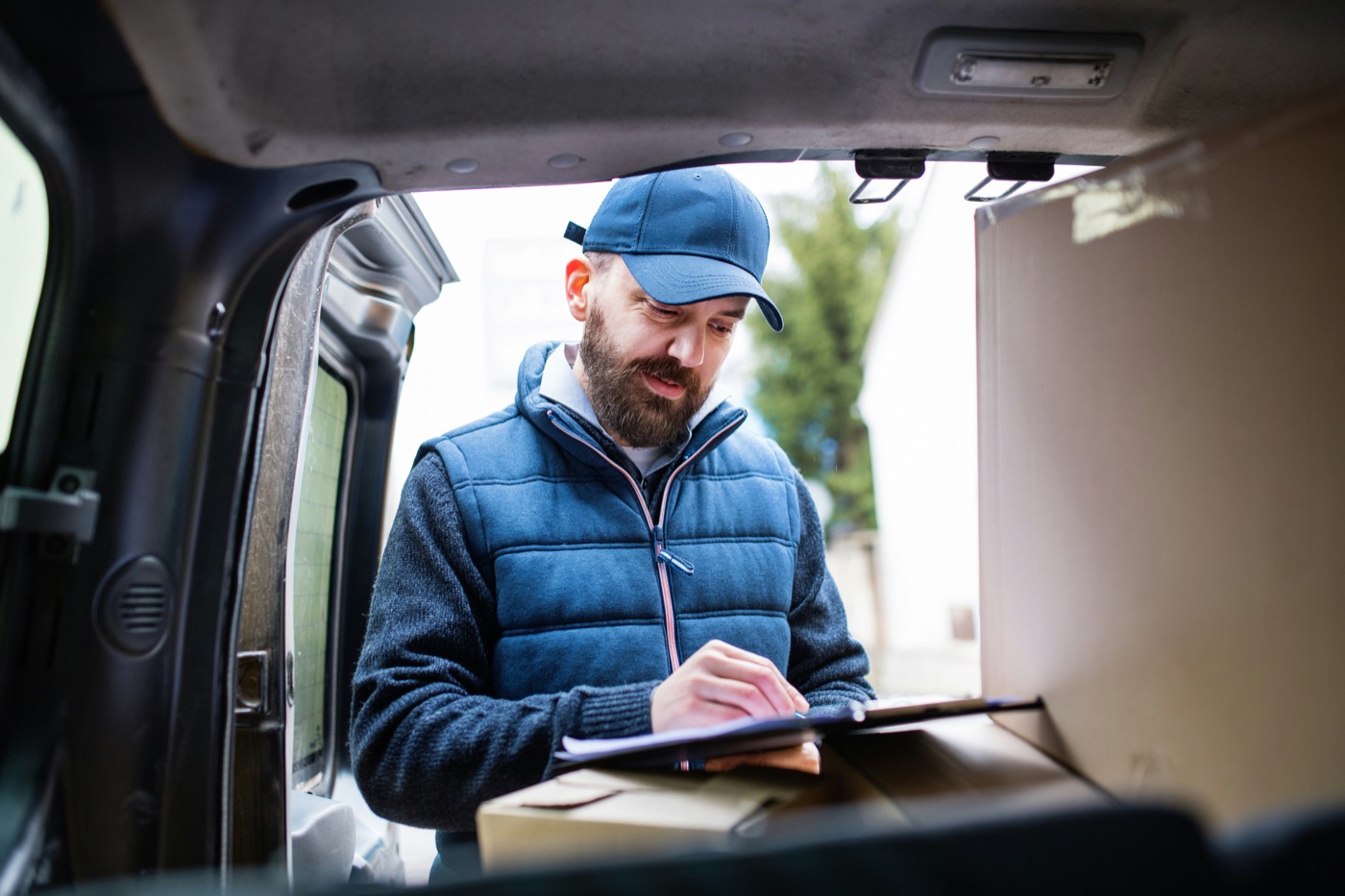 A delivery driver checking orders during a shift