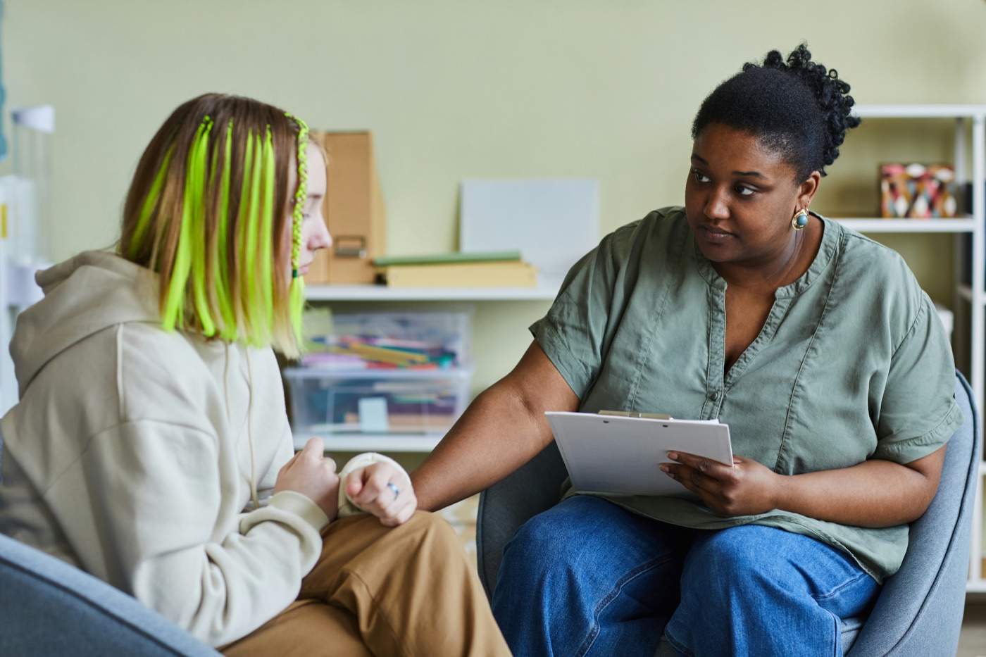 A care worker supporting someone on a tablet
